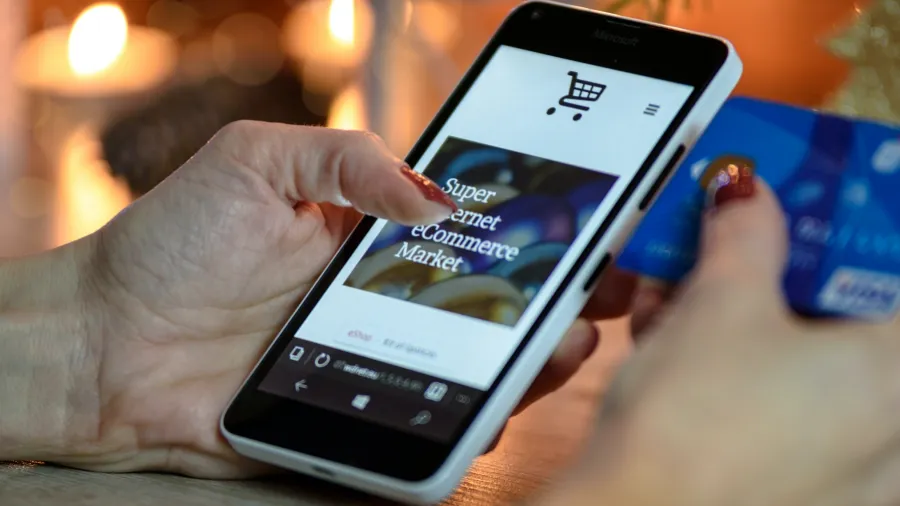 Photo by PhotoMIX Company: https://www.pexels.com/photo/person-using-black-and-white-smartphone-and-holding-blue-card-230544/