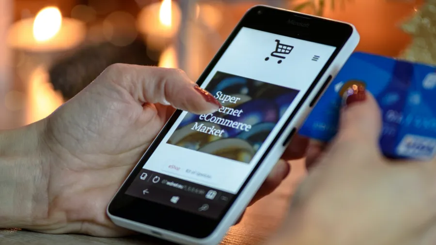 Photo by PhotoMIX Company: https://www.pexels.com/photo/person-using-black-and-white-smartphone-and-holding-blue-card-230544/