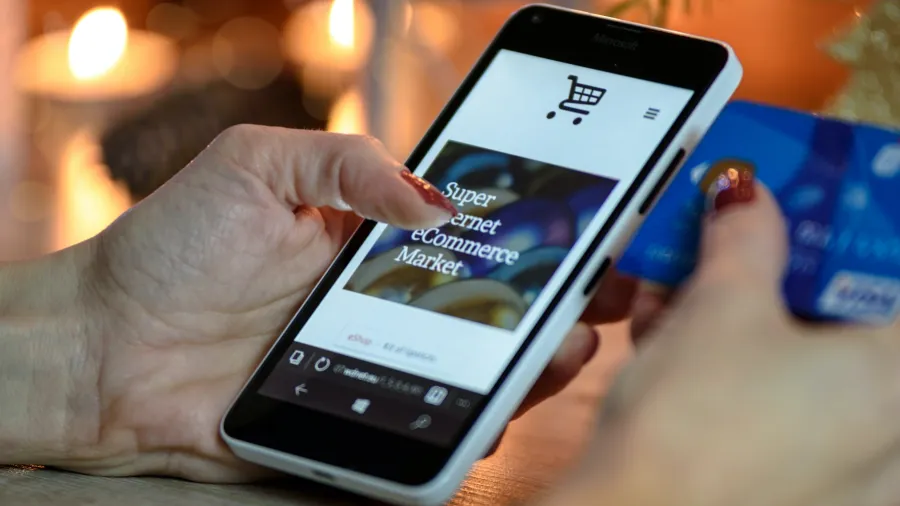 Photo by PhotoMIX Company: https://www.pexels.com/photo/person-using-black-and-white-smartphone-and-holding-blue-card-230544/