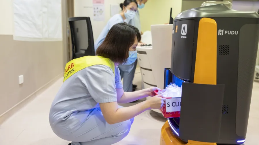 Nurse retrieves medicine from the MEDi robot. Image source: CHI