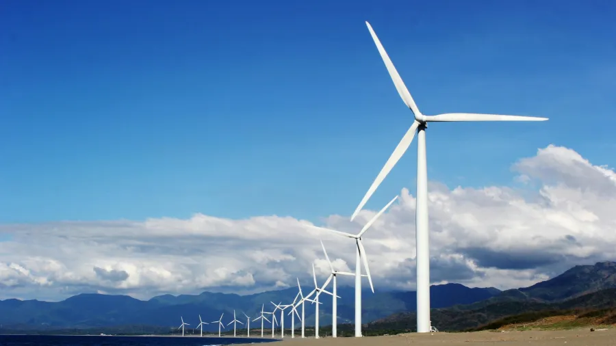 Photo by Kervin Edward Lara: https://www.pexels.com/photo/white-wind-turbines-on-gray-sand-near-body-of-water-3976320/