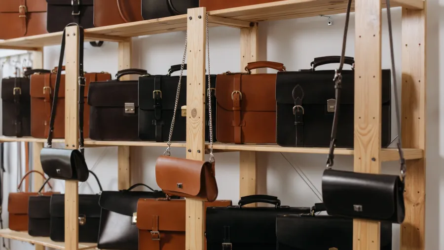 Photo by cottonbro studio: https://www.pexels.com/photo/leather-bags-on-wooden-shelves-6648416/