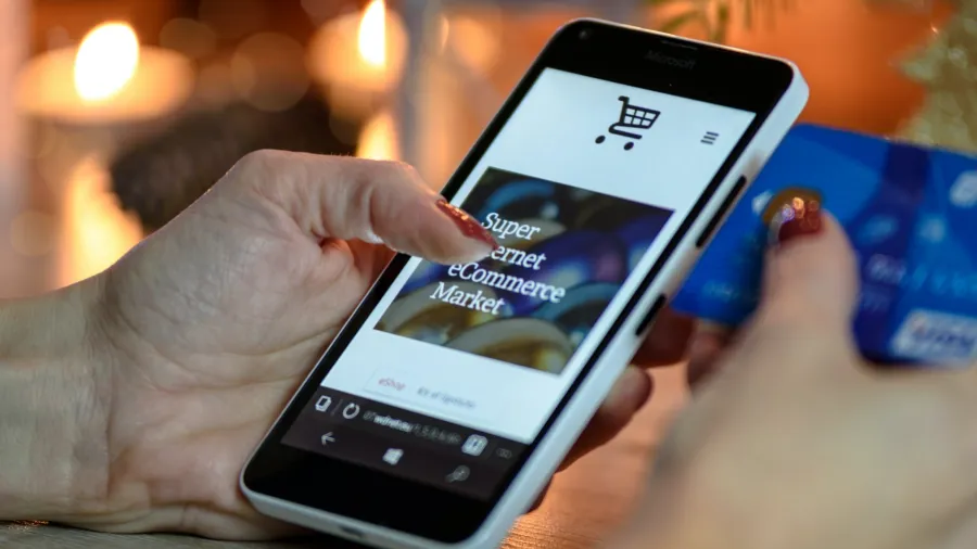 Photo by PhotoMIX Company: https://www.pexels.com/photo/person-using-black-and-white-smartphone-and-holding-blue-card-230544/