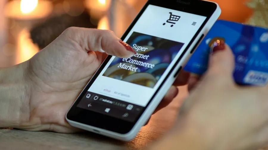 Photo by PhotoMIX Company: https://www.pexels.com/photo/person-using-black-and-white-smartphone-and-holding-blue-card-230544/