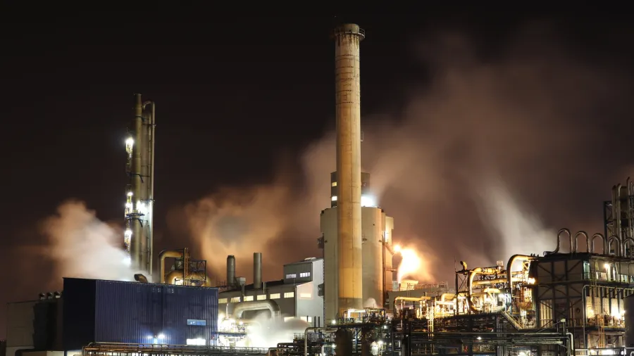 Photo by Loïc Manegarium: https://www.pexels.com/photo/brown-and-white-factory-building-during-night-time-3855962/