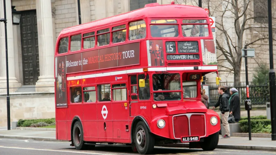 One of the iconic red double decker buses in London. Photo by Dave Kim via Unsplash.