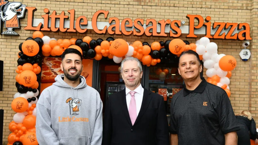 Carlos Vidal, Little Caesars’ Vice President of Development (middle) with franchisees Jas and Ras Sandhu.