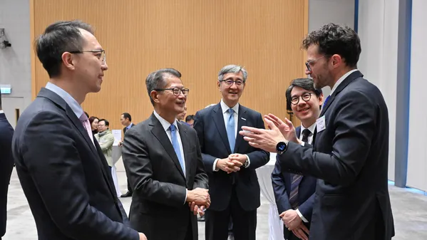Press photo: Financial Secretary Paul Chan (second left) chats with representatives of the strategic enterprises and guests at the OASES Partnership Signing Ceremony.