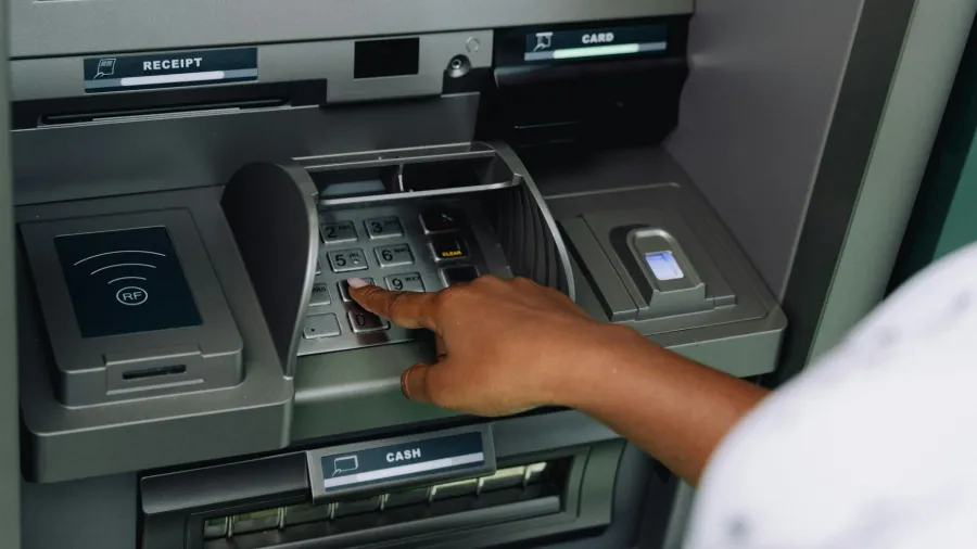 An ATM machine, likely not in Singapore. Photo by Ali Mkumbwa via Unsplash.