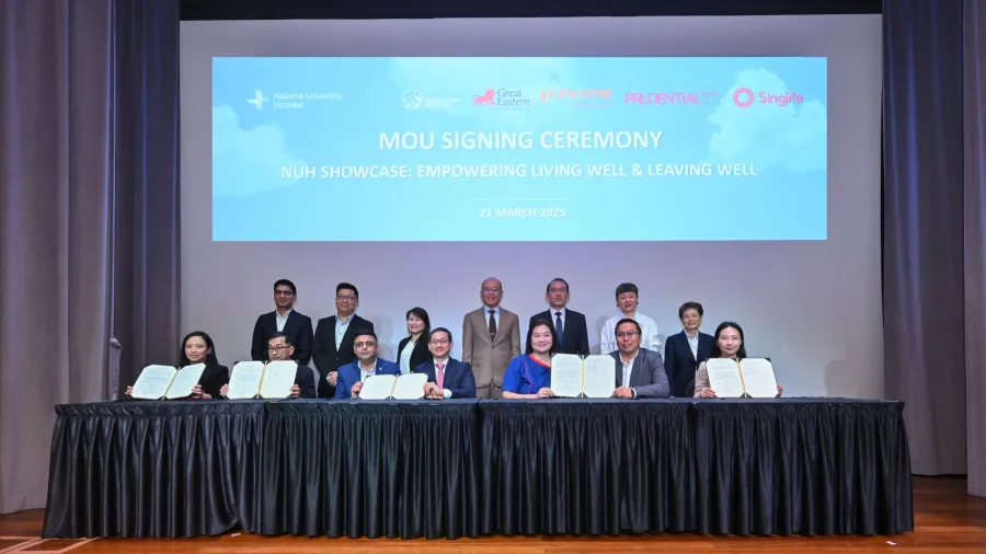 MOU signing with insurers - Adjunct Associate Professor Mark Puhaindran (fourth from left, with pink tie), Chairman, Medical Board, National University Hospital (NUH); and Adjunct Associate Professor Karen Koh (third from right), NUH’s Chief Nurse, with representatives from five insurers at the MOU signing ceremony on 21 March