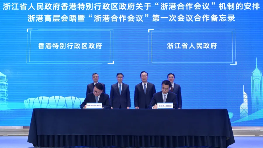 Witnessed by Mr Liu (back row, left), Mr Lee (back row, second left), Mr Wang (back row, second right) and Mr Zhou (back row, right), Chief Secretary Chan Kwok-ki (front row, left) and Zhejiang Vice Governor Lu Shan (front row, right) sign co-operation pacts.