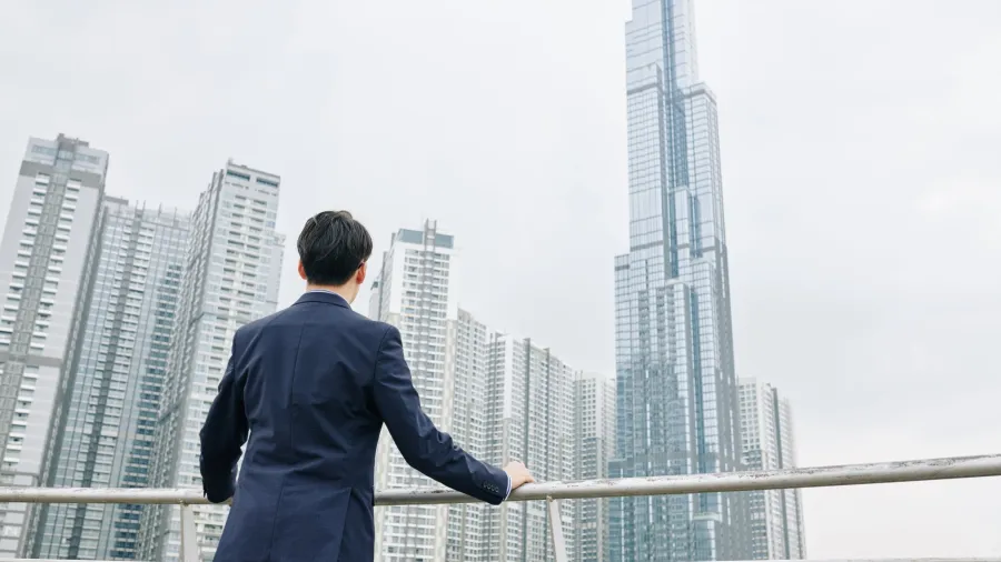 Entrepreneur looking at skyscrapers in Hong Kong