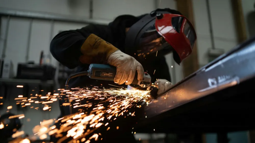 Manufacturing momentum eases in March but PMI still signals expansion